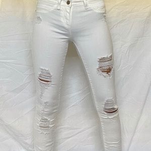 Bebe white  ripped skinny jeans